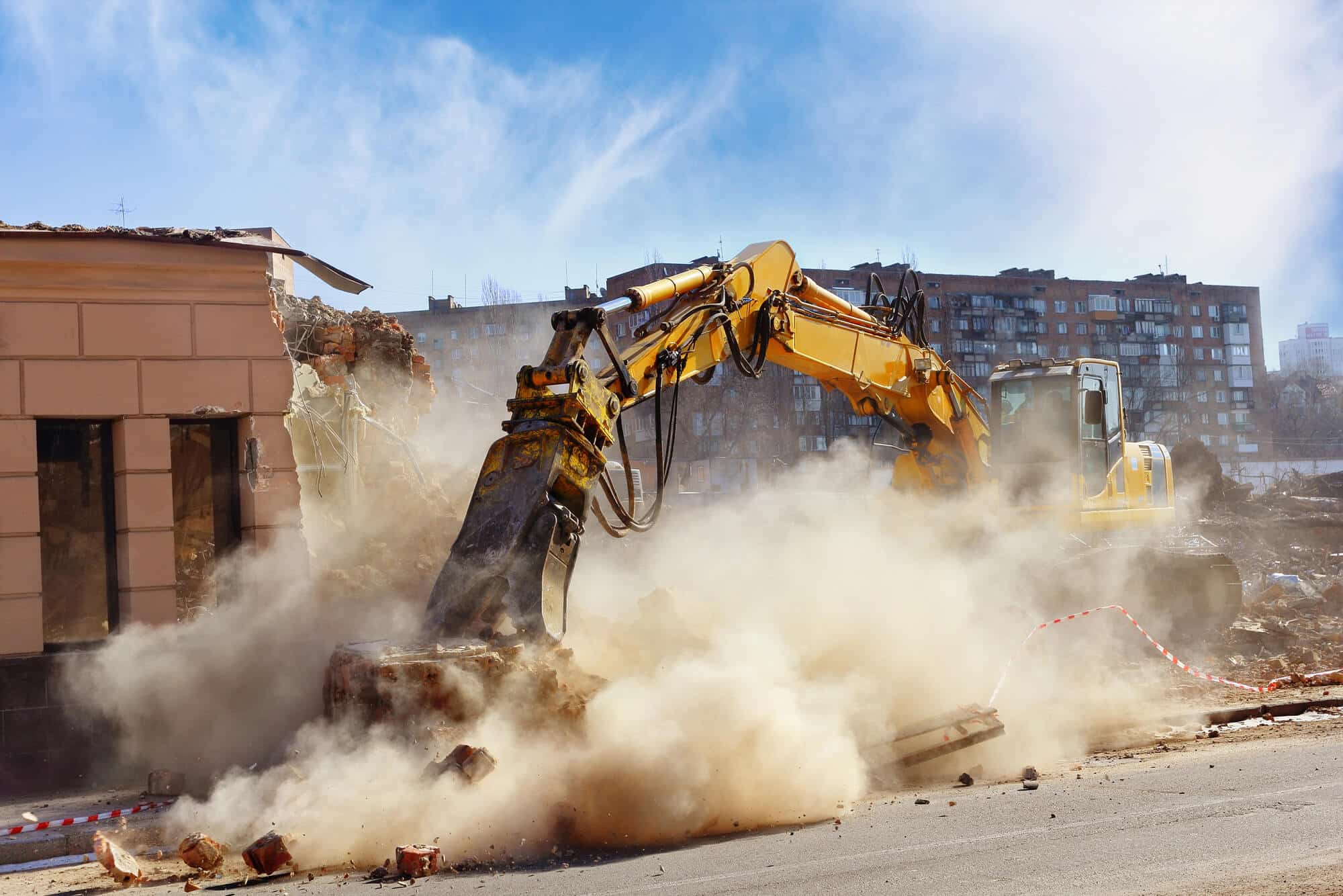 Demolition excavator removing a residential structure