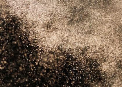 Water spray suppressing dust during concrete demolition work