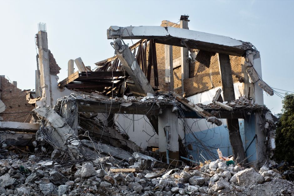 tilt-wall concrete panel being removed during a big-box store demolition